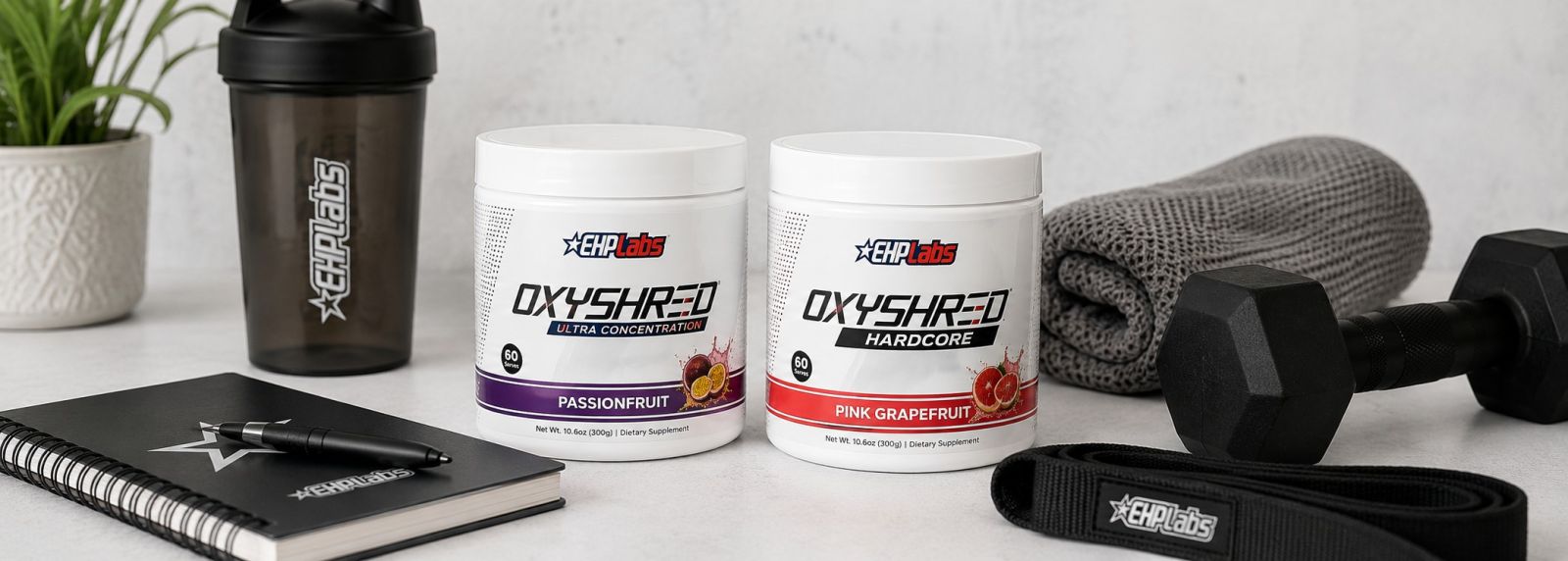 EHP Labs OxyShred supplements with shaker, training notebook and gym accessories